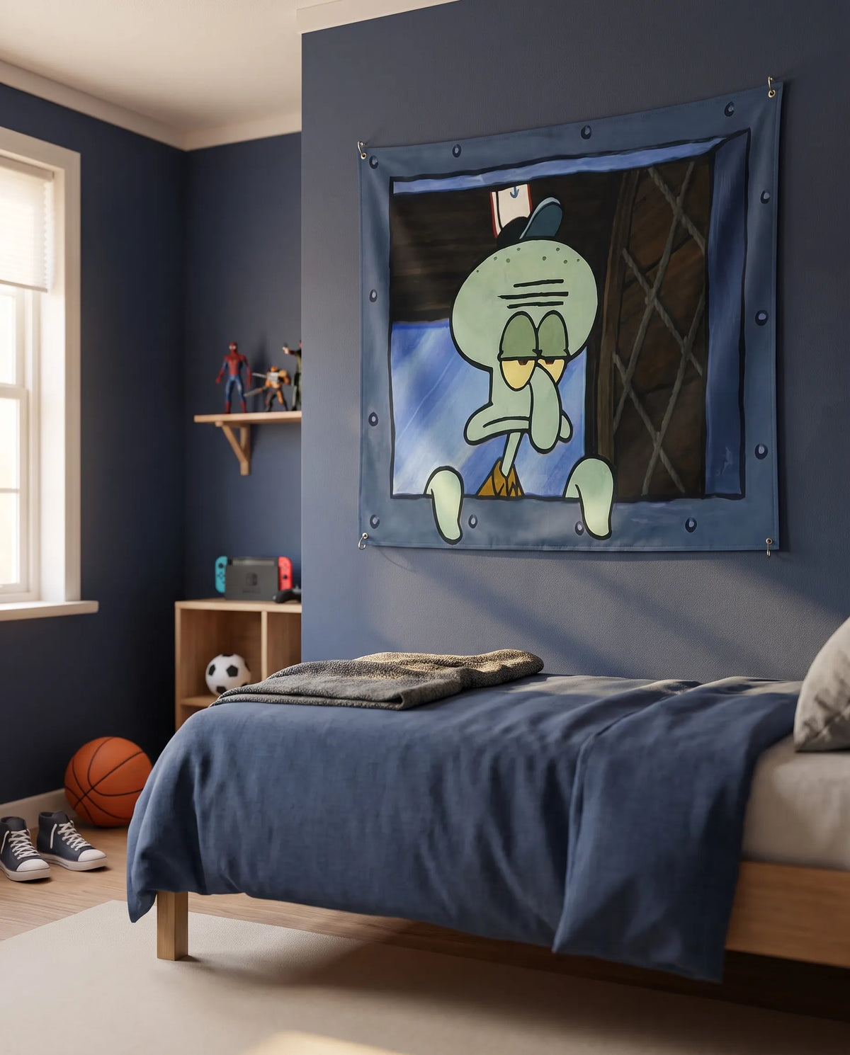 A navy blue wall tapestry featuring the cartoon character Squidward from SpongeBob SquarePants, hanging on a dark blue wall in a styled children's bedroom with a bed, basketball, and sneakers.