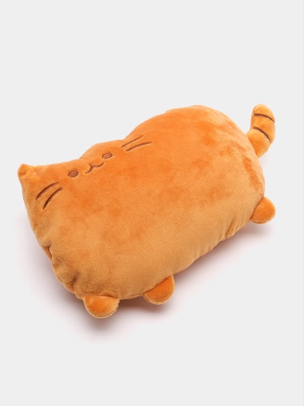 An orange cat-shaped plush pillow with embroidered facial features and small raised paws and tail tips, photographed on a clean light gray background.